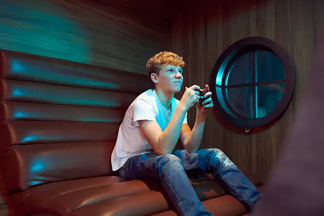 A boy playing video games on a P&O Cruises ship