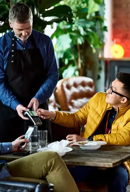 People paying for a meal via an ePOS device